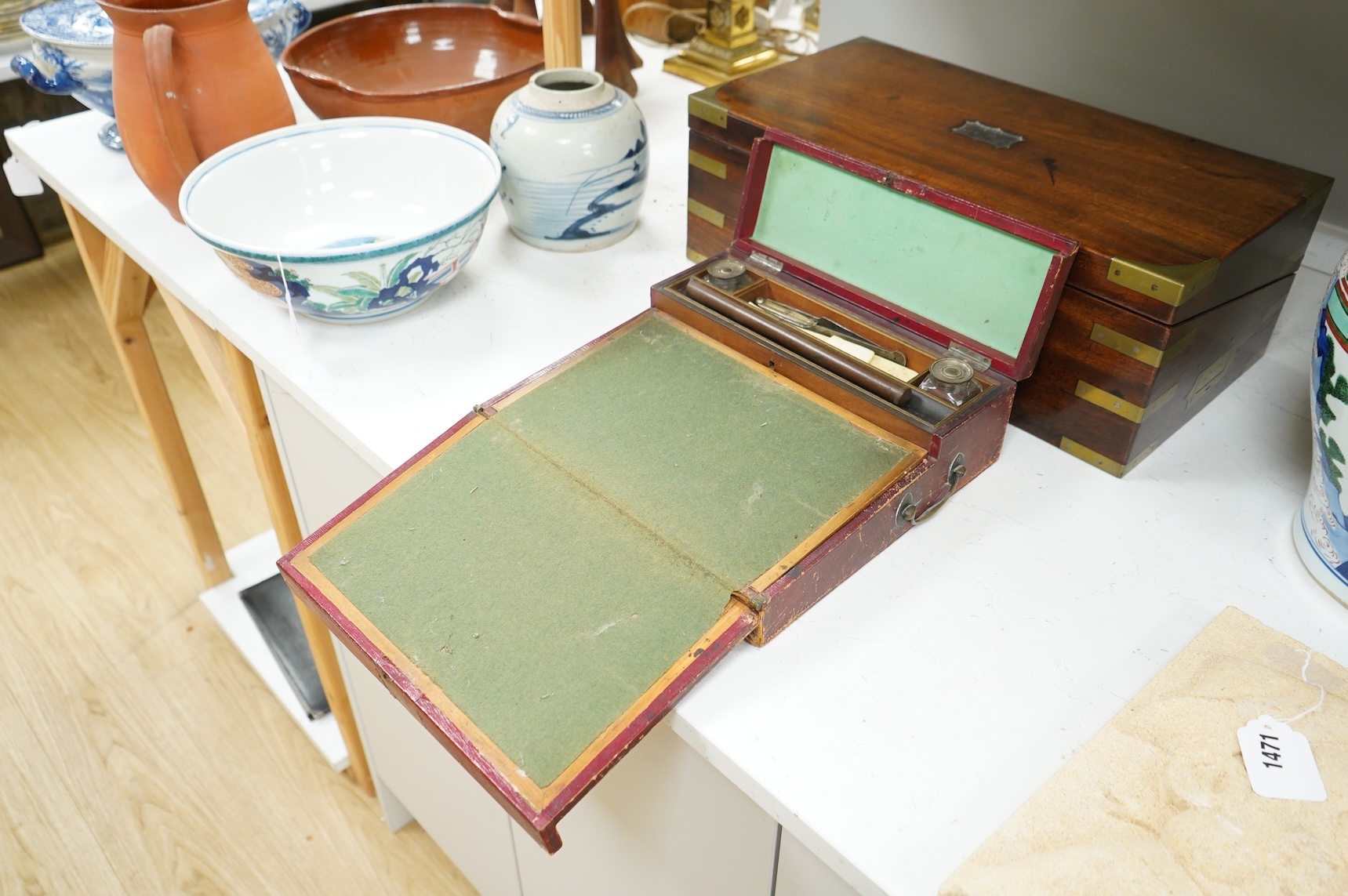 A Victorian brass bound mahogany writing slope and a Regency leather covered writing slope, 50cm wide